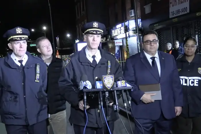 A photo of police and transit officials briefing reporters on a Tuesday night shooting